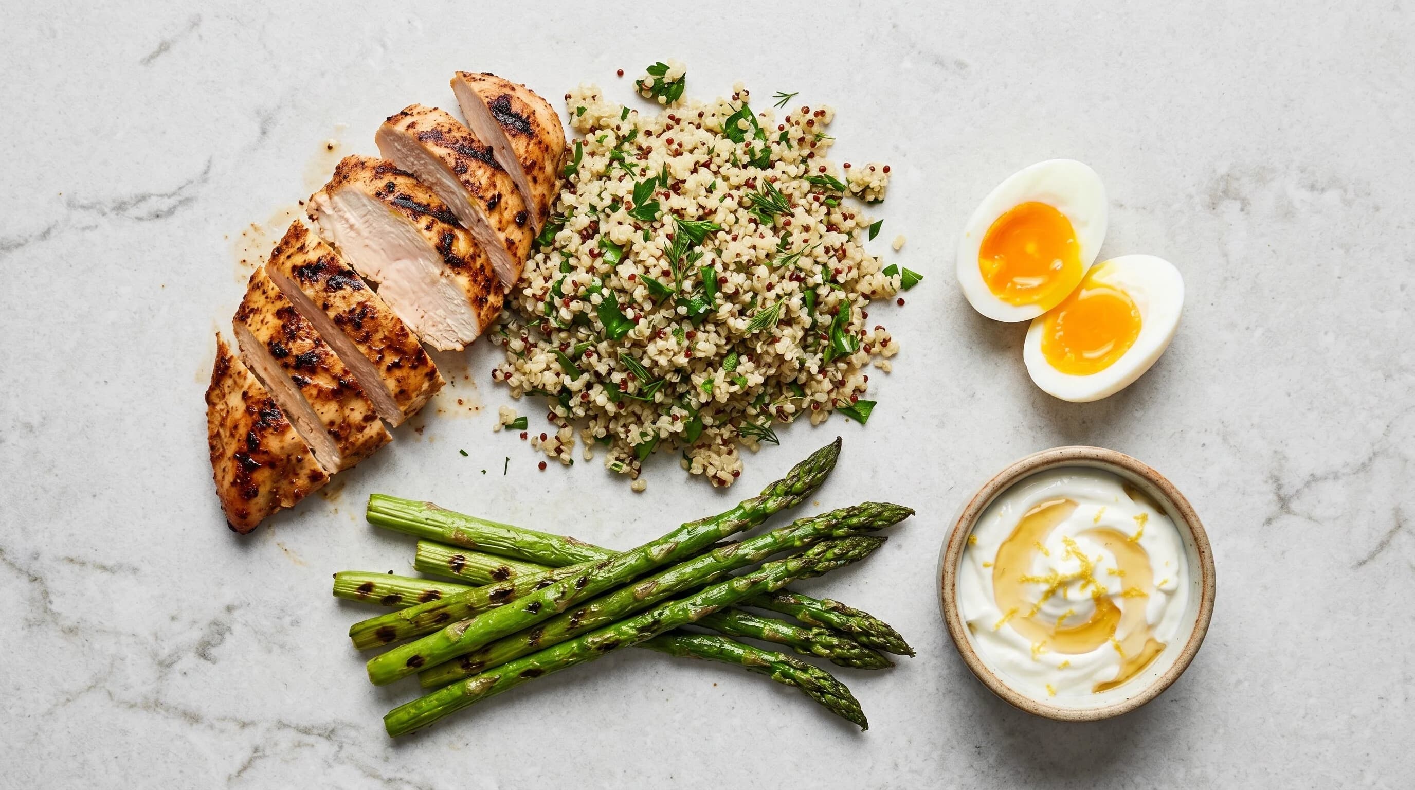 High-protein meal prep with grilled chicken, quinoa, and eggs.